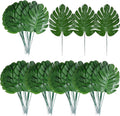 XONOR 100Pcs Artificial Monstera Leaves Fake Tropical Faux Palm Leaves with Stem for Jungle Hawaiian Dinosaur Luau Party Table Decoration Wedding Birthday Theme Party, Leaf Size: 7''x 5''
